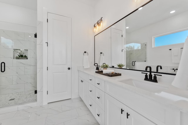 bathroom featuring vanity and a shower with shower door