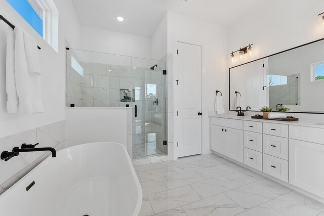 bathroom featuring vanity, separate shower and tub, and tile walls