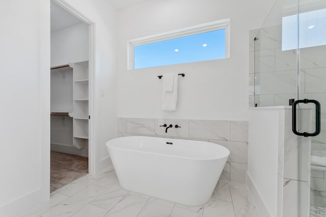 bathroom featuring shower with separate bathtub