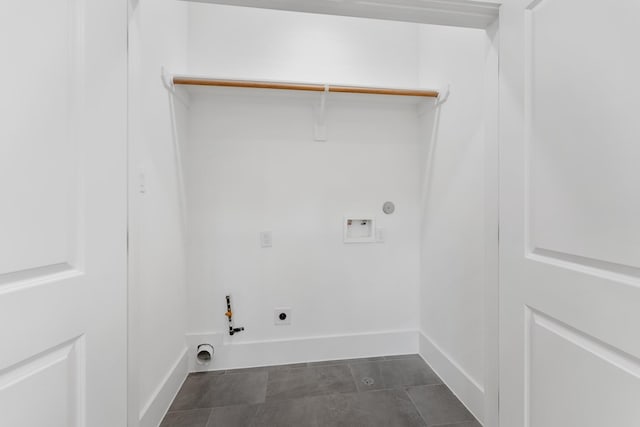 laundry area with gas dryer hookup, dark tile patterned floors, washer hookup, and hookup for an electric dryer