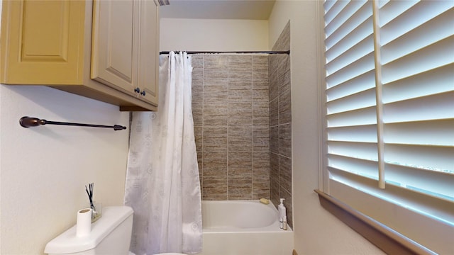 bathroom with toilet and shower / tub combo