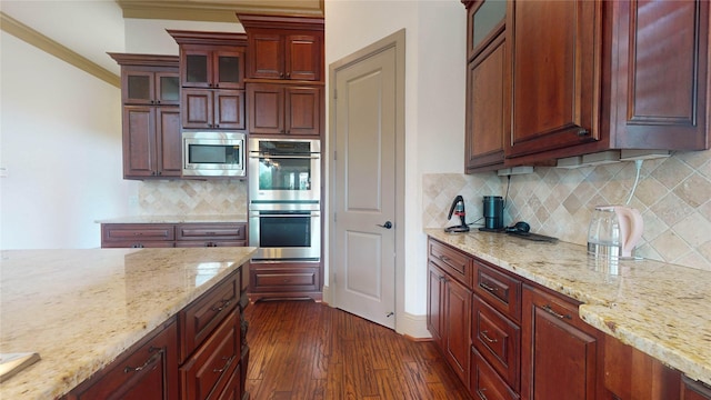 kitchen featuring dark hardwood / wood-style floors, decorative backsplash, light stone countertops, and stainless steel appliances