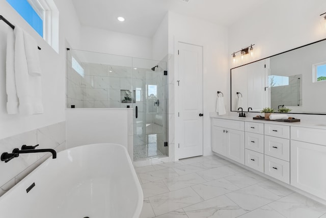 bathroom with separate shower and tub, vanity, and tile walls