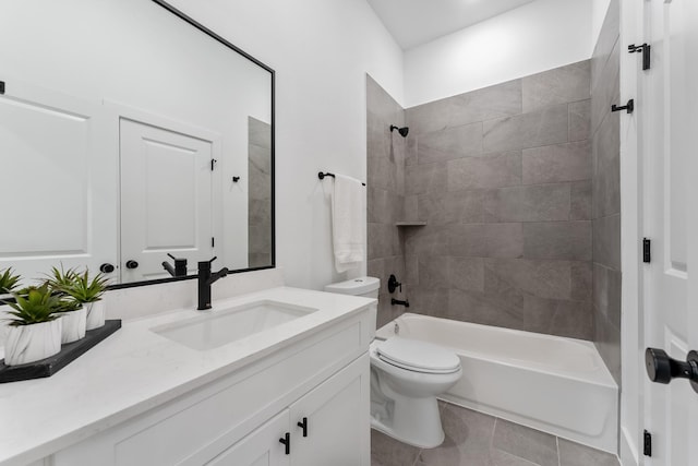 full bathroom featuring tile patterned flooring, vanity, toilet, and tiled shower / bath