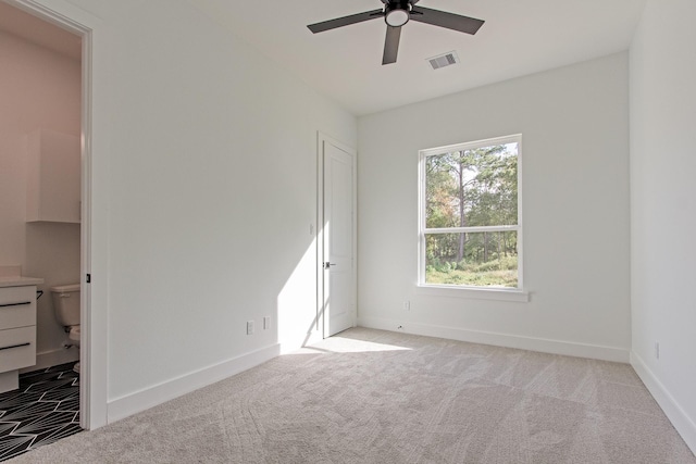 carpeted empty room featuring ceiling fan