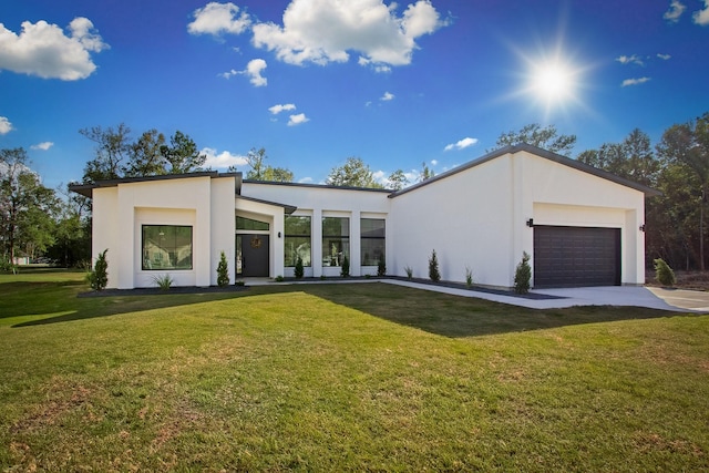 contemporary home with a garage and a front yard