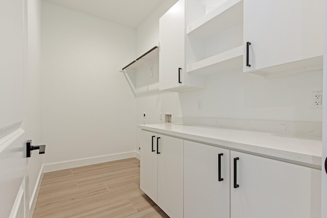 laundry room with hookup for a washing machine, cabinets, and hookup for an electric dryer