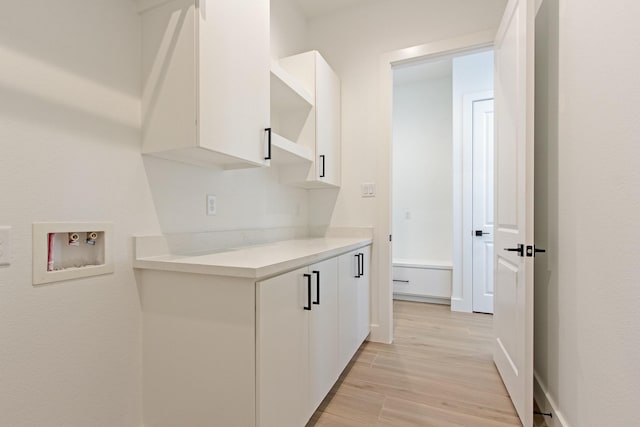 hallway with light hardwood / wood-style flooring