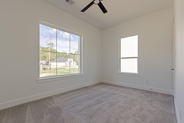 carpeted spare room with ceiling fan