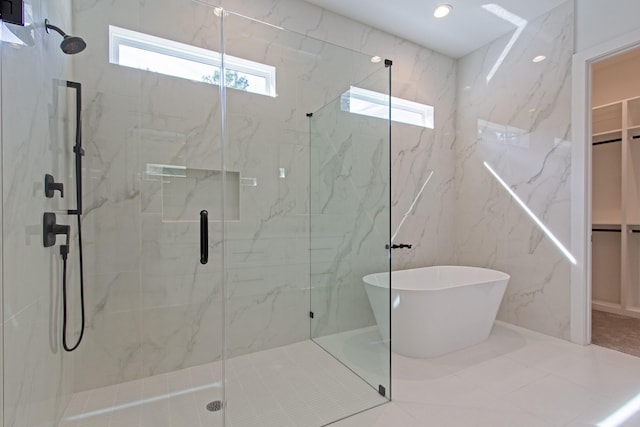 bathroom with a wealth of natural light and shower with separate bathtub