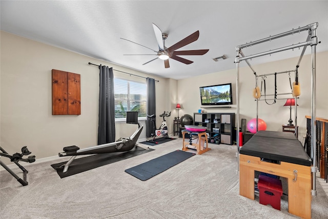 workout room with ceiling fan and carpet