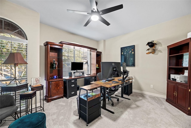 home office featuring ceiling fan, light carpet, and a wealth of natural light