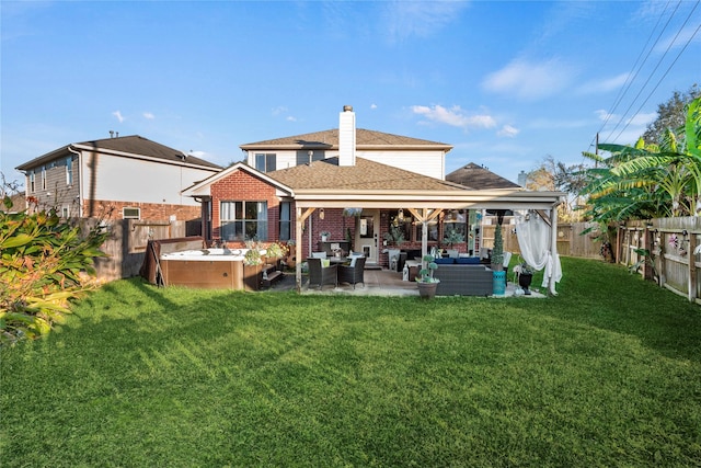 rear view of house featuring a yard, an outdoor living space, and a patio