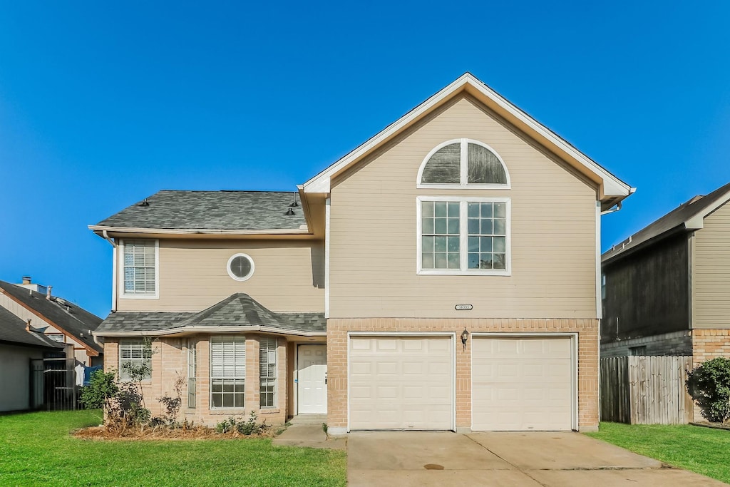 front facade with a front lawn and a garage