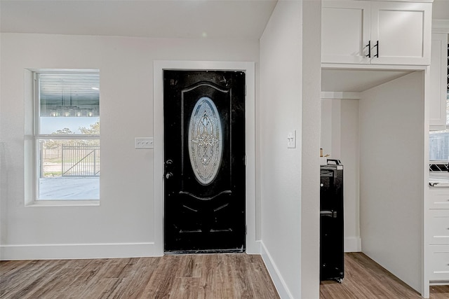 foyer entrance with light hardwood / wood-style floors