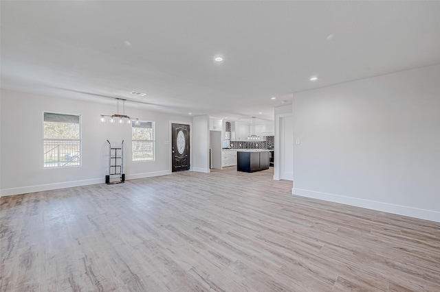 unfurnished living room featuring light hardwood / wood-style floors