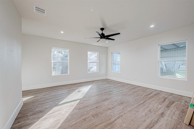 empty room with light hardwood / wood-style flooring and ceiling fan