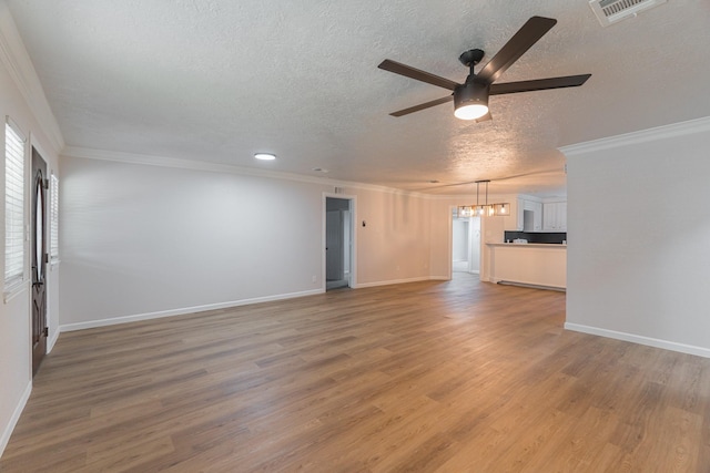 unfurnished living room featuring a textured ceiling, ceiling fan with notable chandelier, wood-type flooring, and crown molding