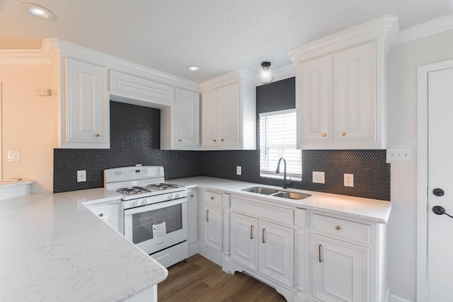 kitchen featuring white gas range oven, crown molding, sink, white cabinets, and dark hardwood / wood-style floors