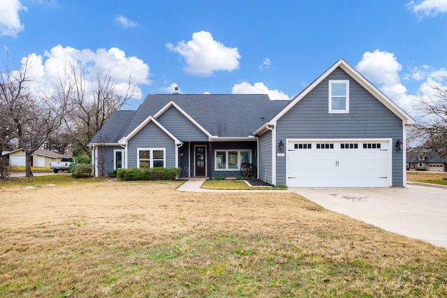 view of front facade with a front yard and a garage