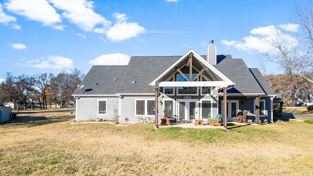 back of house with a yard and a patio area