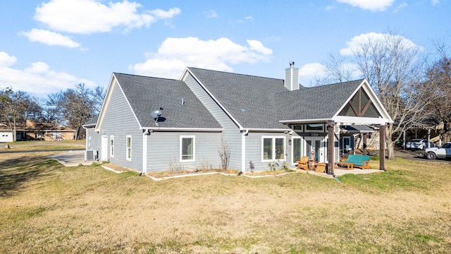 back of house with a yard, a patio, and an outdoor hangout area