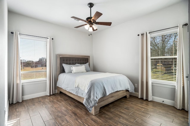 bedroom featuring multiple windows and ceiling fan