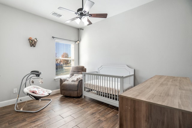 bedroom with ceiling fan and a nursery area