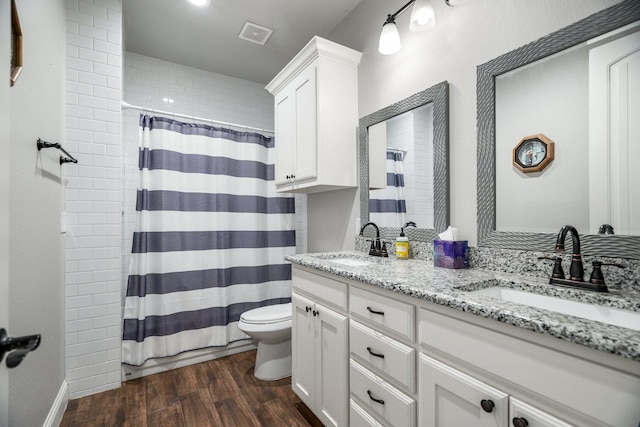 bathroom with vanity, curtained shower, toilet, and wood-type flooring