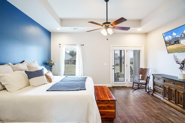 bedroom featuring access to outside, ceiling fan, and a tray ceiling