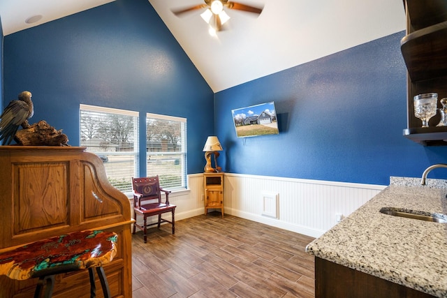 sitting room featuring hardwood / wood-style floors, ceiling fan, sink, and a wealth of natural light