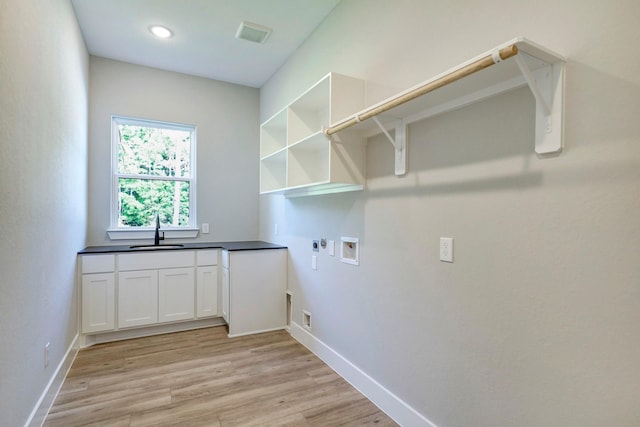 laundry room with sink, hookup for an electric dryer, hookup for a gas dryer, hookup for a washing machine, and light wood-type flooring