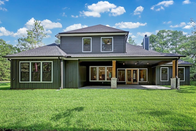 rear view of house featuring a lawn, ceiling fan, french doors, and a patio