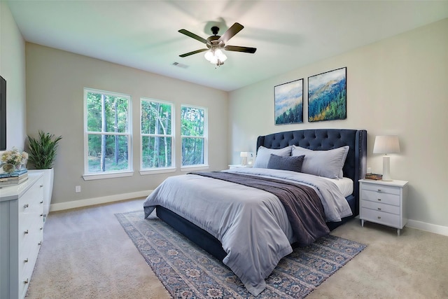 bedroom with ceiling fan and light colored carpet