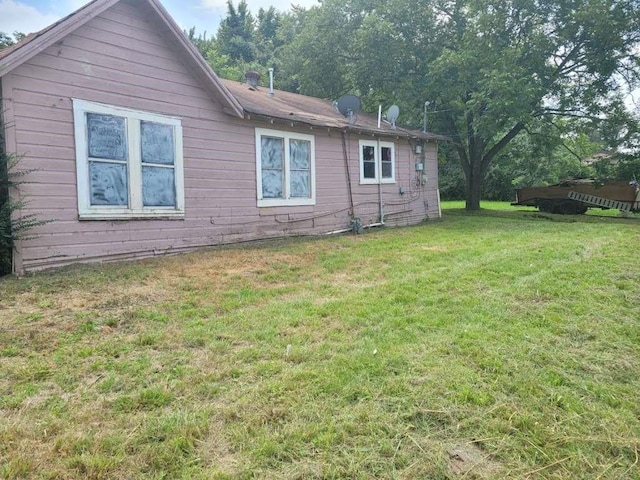 view of side of home featuring a lawn