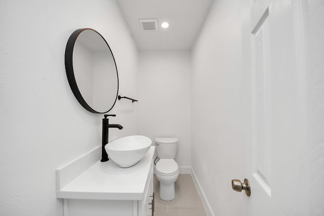 bathroom featuring vanity, toilet, and tile patterned flooring