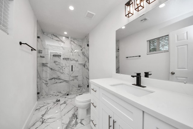 bathroom featuring walk in shower, vanity, and toilet