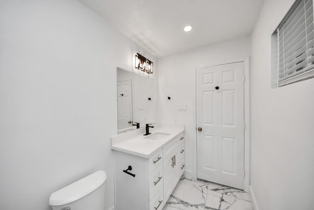 bathroom featuring vanity and toilet