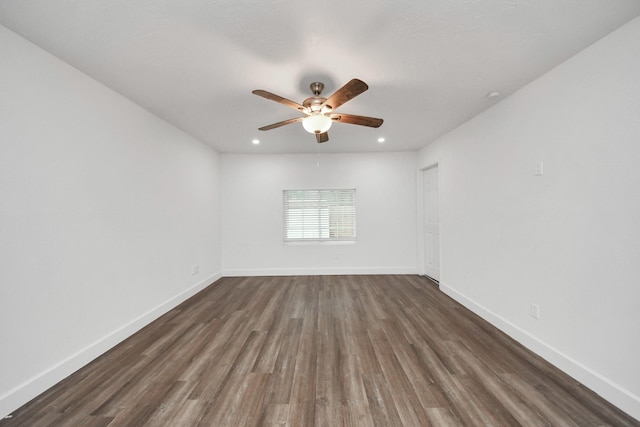 empty room featuring ceiling fan and dark hardwood / wood-style floors