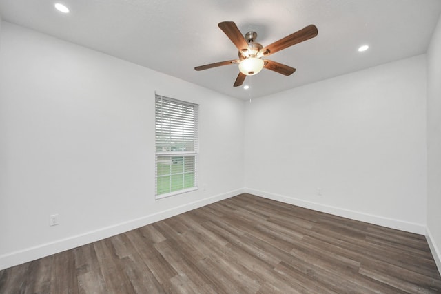 empty room with dark hardwood / wood-style floors and ceiling fan