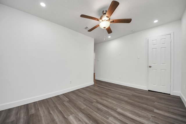 spare room featuring ceiling fan and dark hardwood / wood-style flooring