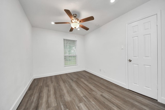 unfurnished room featuring ceiling fan and dark hardwood / wood-style flooring