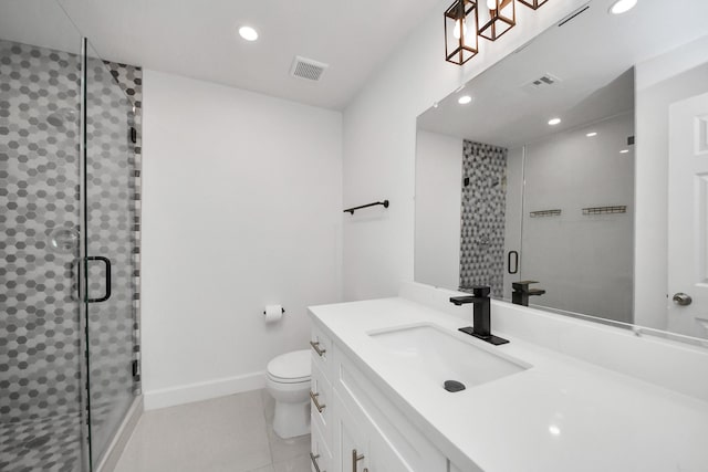 bathroom with tile patterned flooring, vanity, an enclosed shower, and toilet