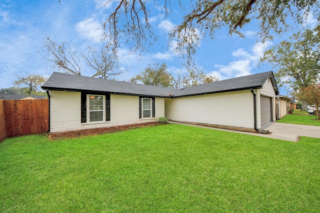 ranch-style home featuring a garage and a front lawn