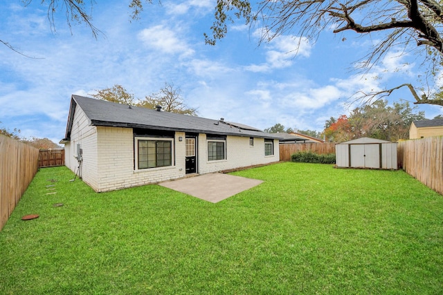 rear view of house featuring a yard, a shed, and a patio area