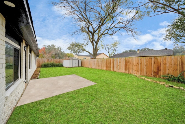 view of yard featuring a storage shed and a patio