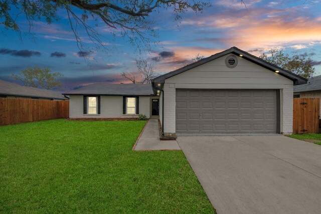 ranch-style home with a lawn