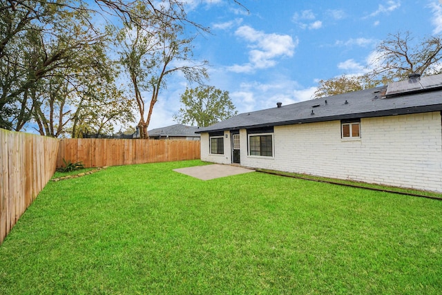 rear view of house with a yard and a patio area