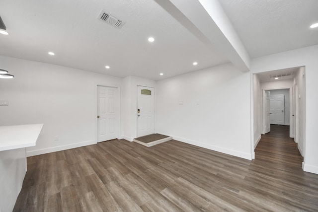 spare room featuring dark wood-type flooring