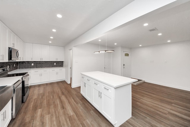 kitchen featuring white cabinetry, pendant lighting, stainless steel appliances, and a center island